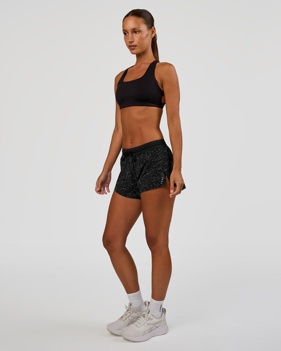 Woman wearing Accelerate 3" Mid-Rise Running Short - Energy Print Black | Model:Brylee | Size:XS