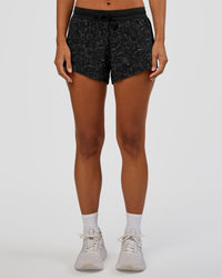 Woman wearing Accelerate 3" Mid-Rise Running Short - Energy Print Black | Set:true | Angle:front | Model:Brylee | Size:XS