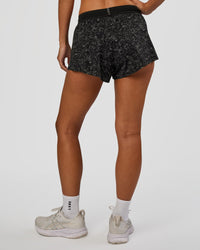 Woman wearing Accelerate 3" Mid-Rise Running Short - Energy Print Black | Set:true | Angle:back | Model:Brylee | Size:XS
