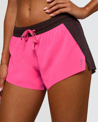 Woman wearing Accelerate 3" Mid-Rise Running Short - Midnight Plum-Sugar Plum | Set:True | Angle:closeup | Model:Charli | Size:XS | Thumbnail Index: 0