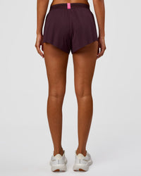 Woman wearing Accelerate 3" Mid-Rise Running Short - Midnight Plum-Sugar Plum | Set:True | Angle:back | Model:Charli | Size:XS | Thumbnail Index: 3