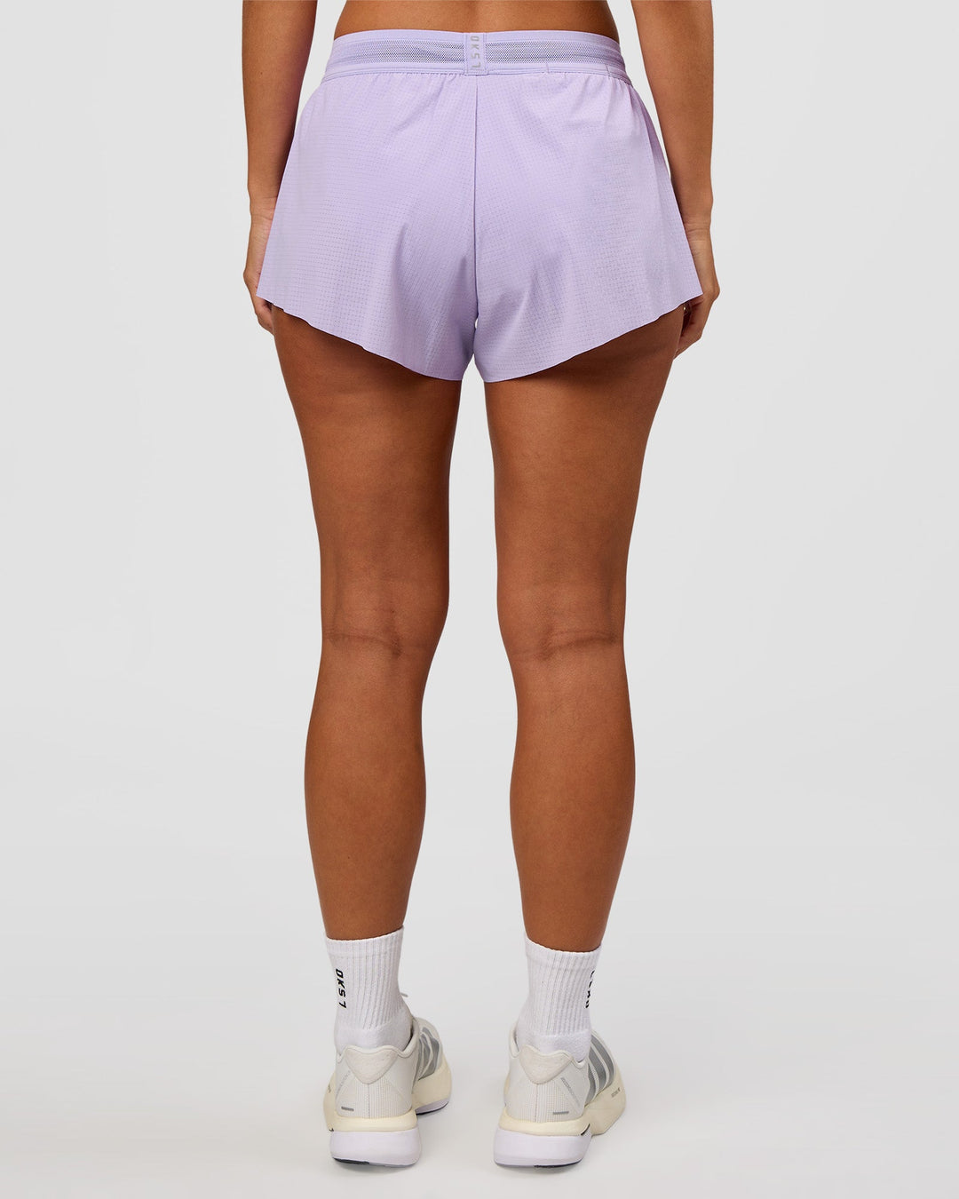 Woman wearing Accelerate 3" Mid-Rise Running Short - Pale Lilac | Set:true | Angle:back | Model:Brylee | Size:XS