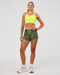 Woman wearing Accelerate Split Strap Sports Bra - Hyper Green | Model:Emelia | Size:XS