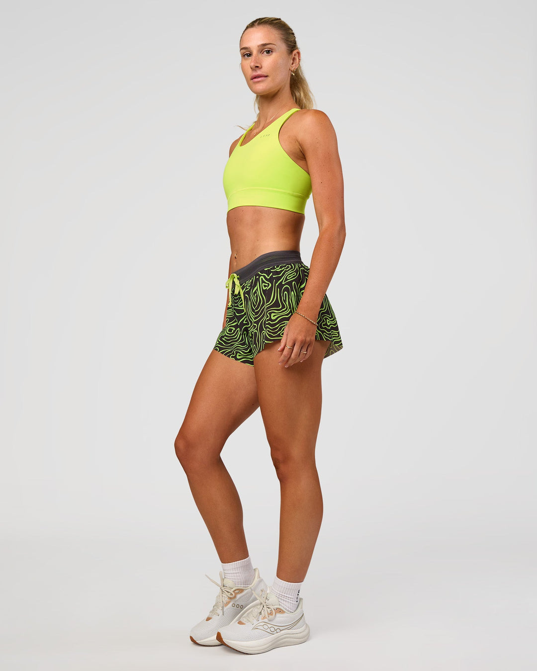Woman wearing Accelerate Split Strap Sports Bra - Hyper Green | Model:Emelia | Size:XS