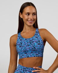 Woman wearing Accelerate Sports Bra in Energy Print Blue Multi | Model:Brylee | Size:XS