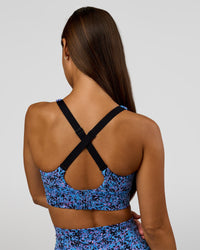 Woman wearing Accelerate Sports Bra in Energy Print Blue Multi | Model:Brylee | Size:XS