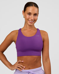 Woman wearing Accelerate Sports Bra - Fresh Purple | Set:true | Angle:front | Model:Brylee | Size:XS