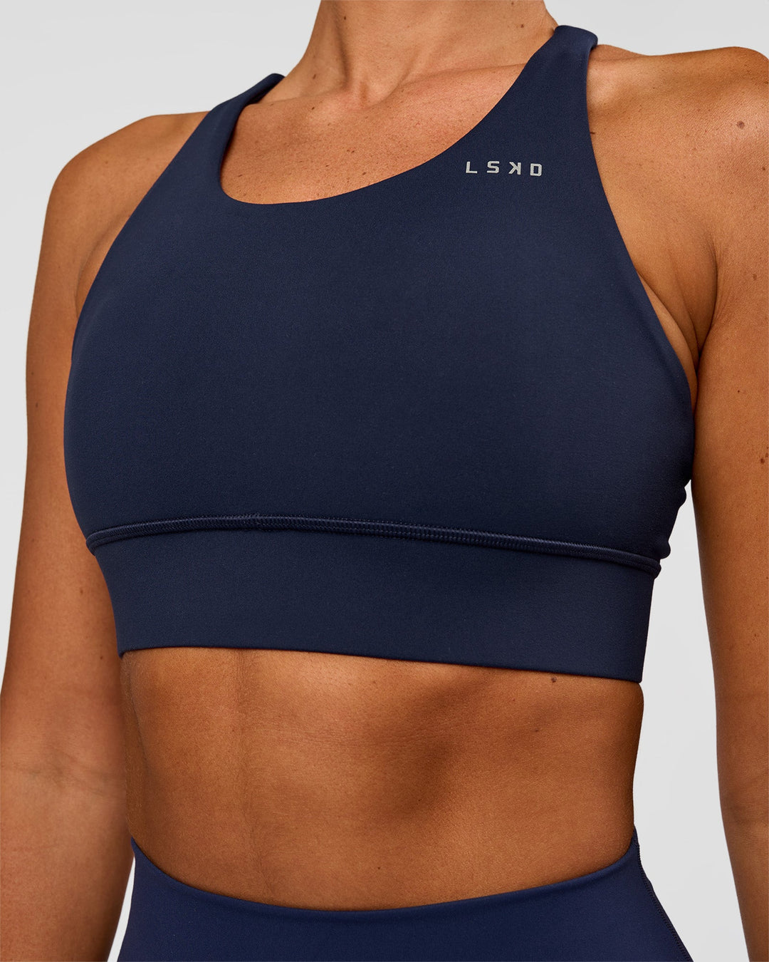 Woman wearing Accelerate Sports Bra - Future Navy | Model:Charlie | Size:XS - view 1