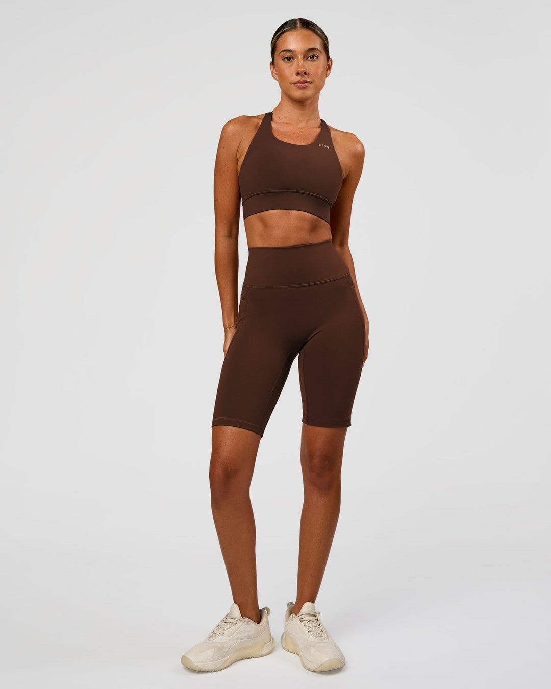 Woman wearing Accelerate Sports Bra - Hot Chocolate | Model:Charli | Size:XS