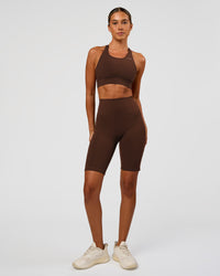 Woman wearing Accelerate Sports Bra - Hot Chocolate | Model:Charli | Size:XS