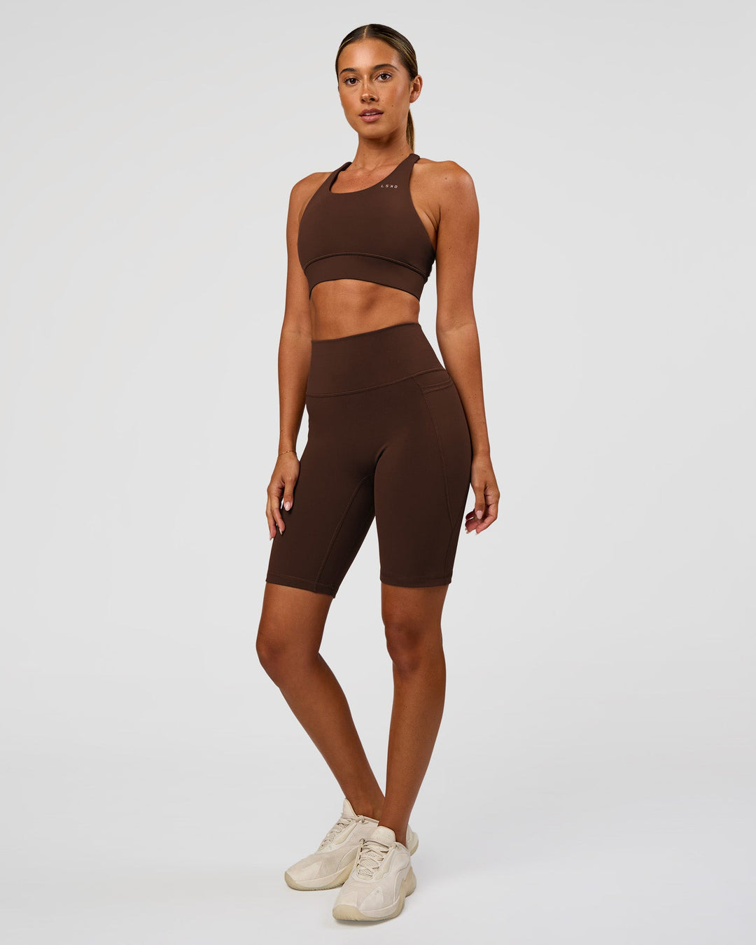 Woman wearing Accelerate Sports Bra - Hot Chocolate | Model:Charli | Size:XS