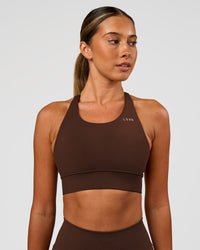 Woman wearing Accelerate Sports Bra - Hot Chocolate | Set:true | Angle:front | Model:Charli | Size:XS | Thumbnail Index: 2