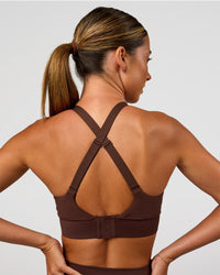 Woman wearing Accelerate Sports Bra - Hot Chocolate | Set:true | Angle:back | Model:Charli | Size:XS | Thumbnail Index: 1