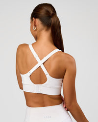 Woman wearing Accelerate Sports Bra - White | Set:true | Angle:back | Model:Brylee | Size:XS | Thumbnail Index: 1