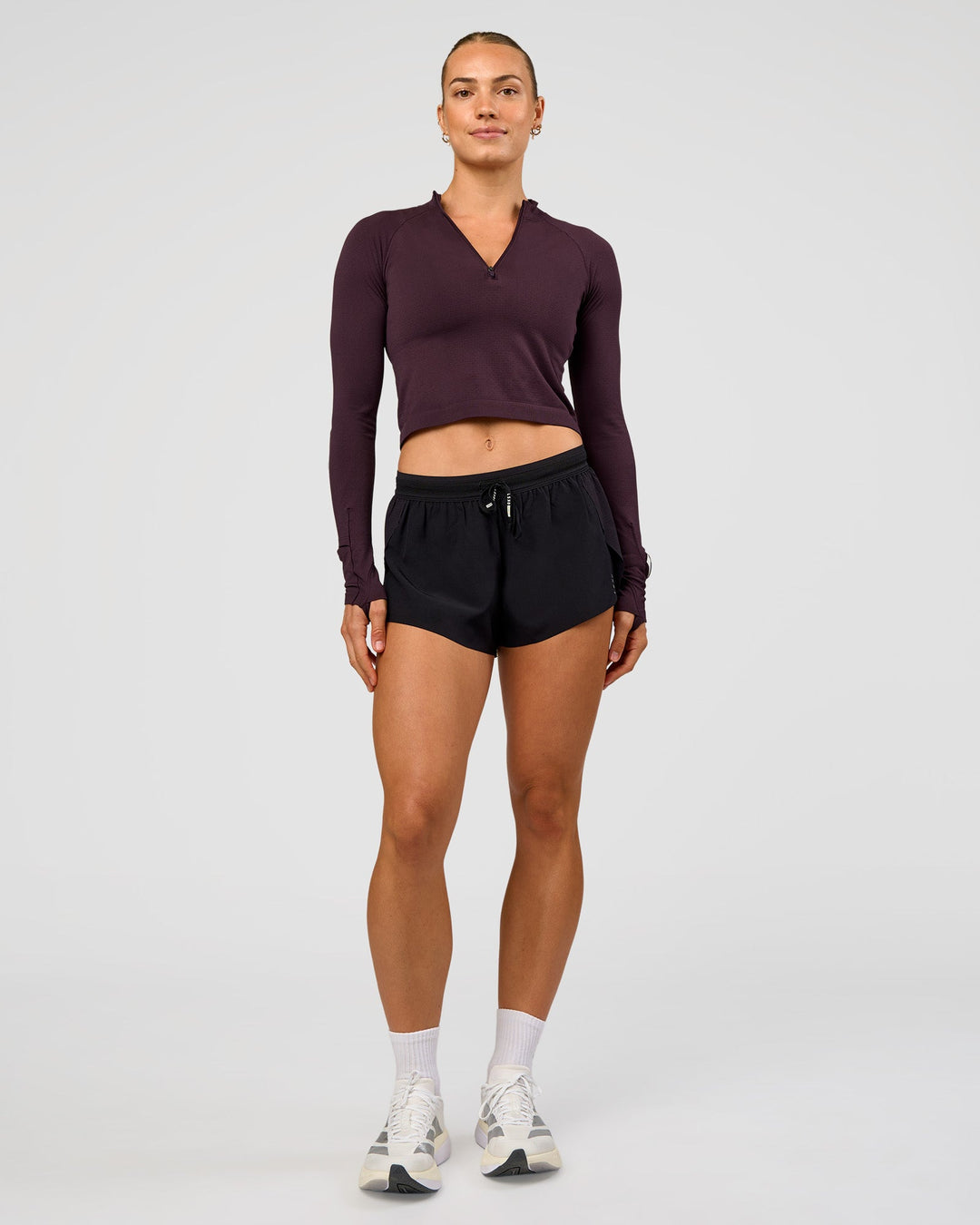 Woman wearing AeroFLX+ Long Sleeve Skimmer Half Zip - Midnight Plum/Midnight Plum | Model:Maja | Size:XS