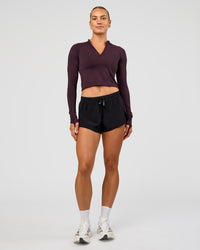 Woman wearing AeroFLX+ Long Sleeve Skimmer Half Zip - Midnight Plum/Midnight Plum | Model:Maja | Size:XS