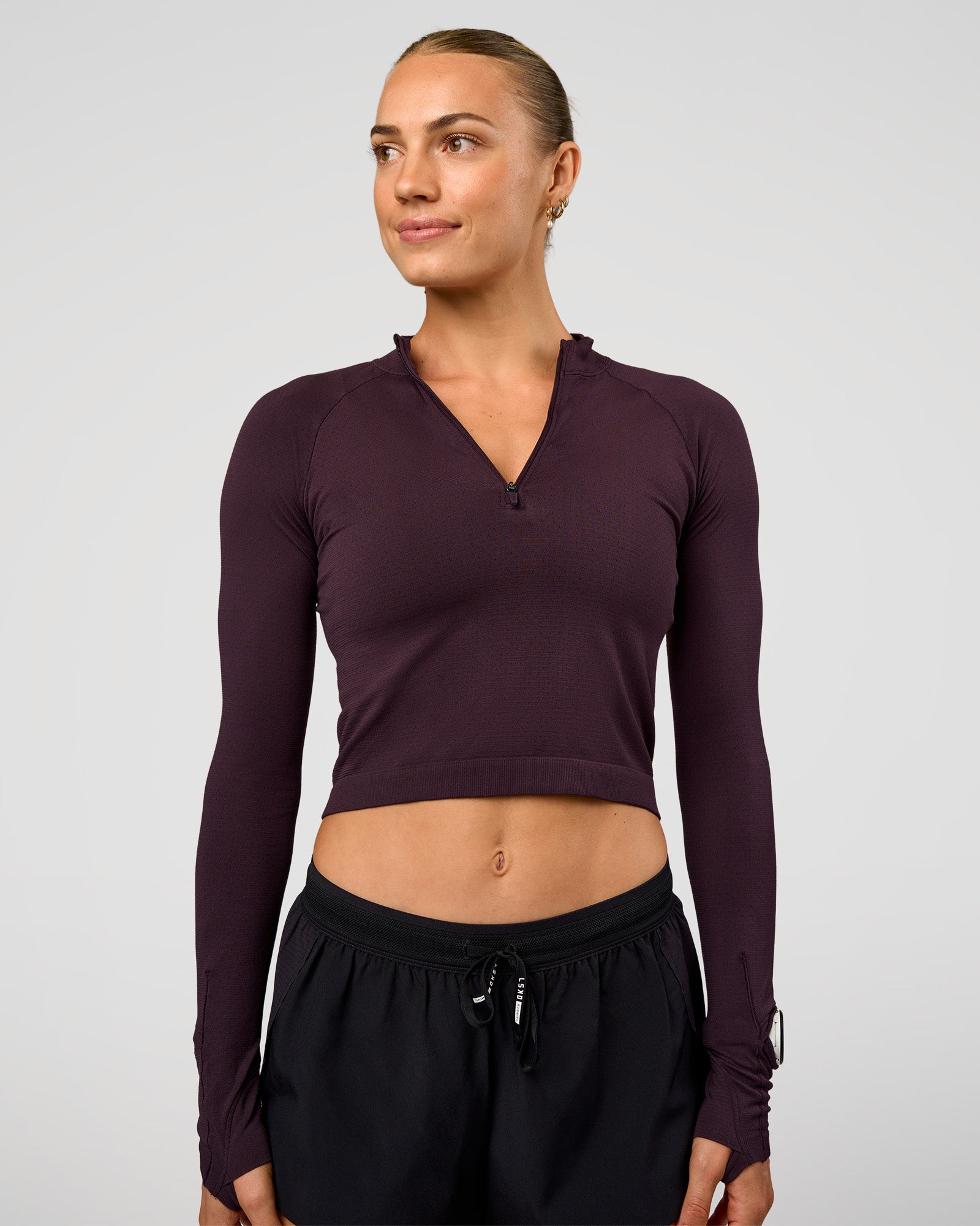 Woman wearing AeroFLX+ Long Sleeve Skimmer Half Zip - Midnight Plum/Midnight Plum | Model:Maja | Size:XS