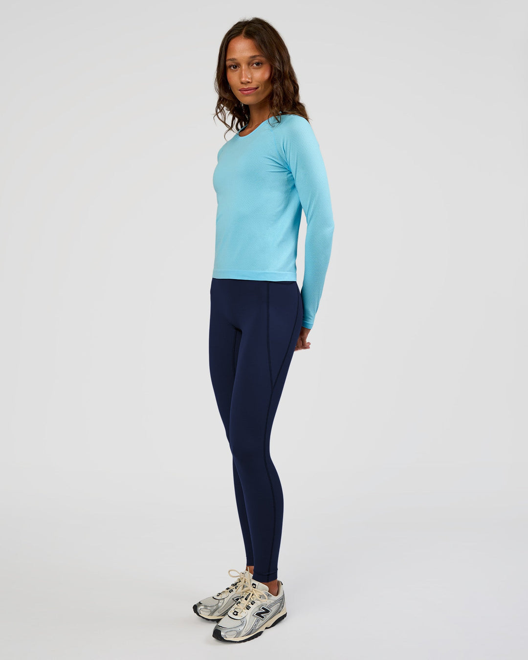 Woman wearing AeroFLX+ Seamless Long Sleeve Tee - Baltic Sea/Baltic Sea | Model:Dakota | Size:XS
