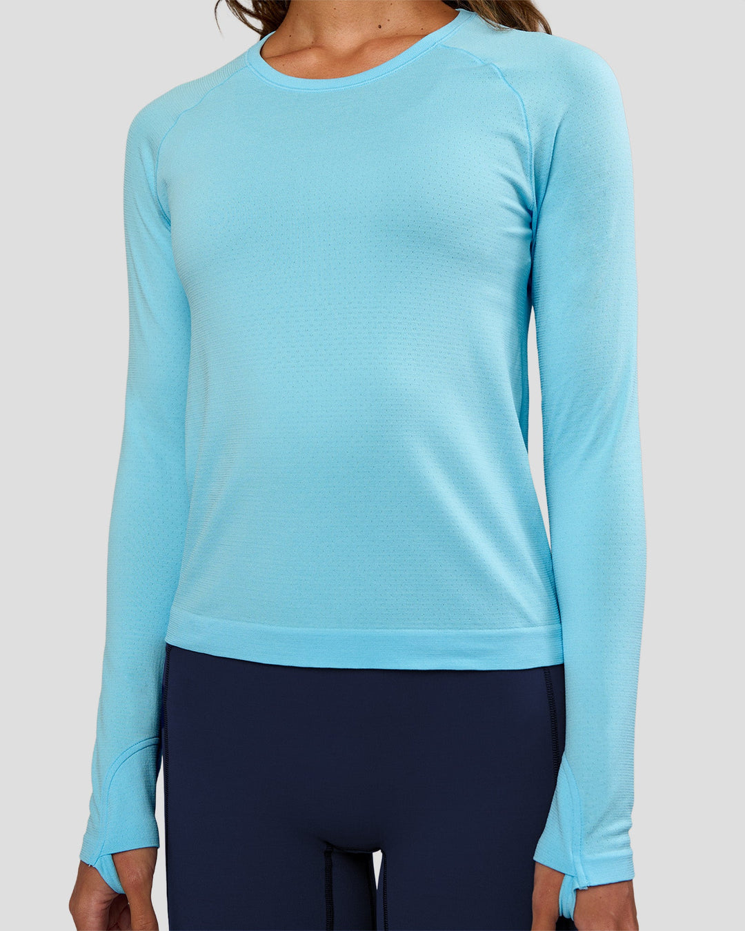 Woman wearing AeroFLX+ Seamless Long Sleeve Tee - Baltic Sea/Baltic Sea | Model:Dakota | Size:XS