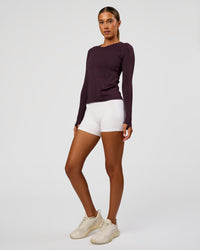 Woman wearing AeroFLX+ Seamless Long Sleeve Tee - Midnight Plum/Midnight Plum | Model:Charli | Size:XS