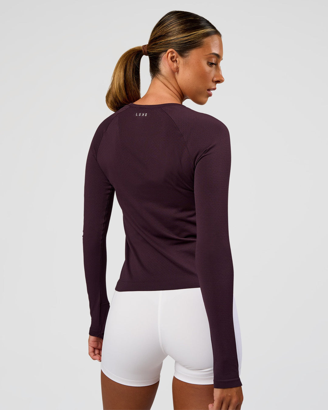 Woman wearing AeroFLX+ Seamless Long Sleeve Tee - Midnight Plum/Midnight Plum | Model:Charli | Size:XS
