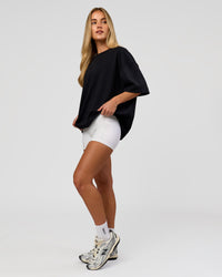 Woman wearing AfterDark ZeroCrease Boxy Tee in Black | Model:Issy | Size:XS