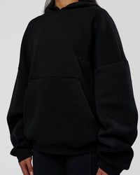Woman wearing AfterDark ZeroCrease Oversized Hoodie - Black | Model:Loren | Size:XS