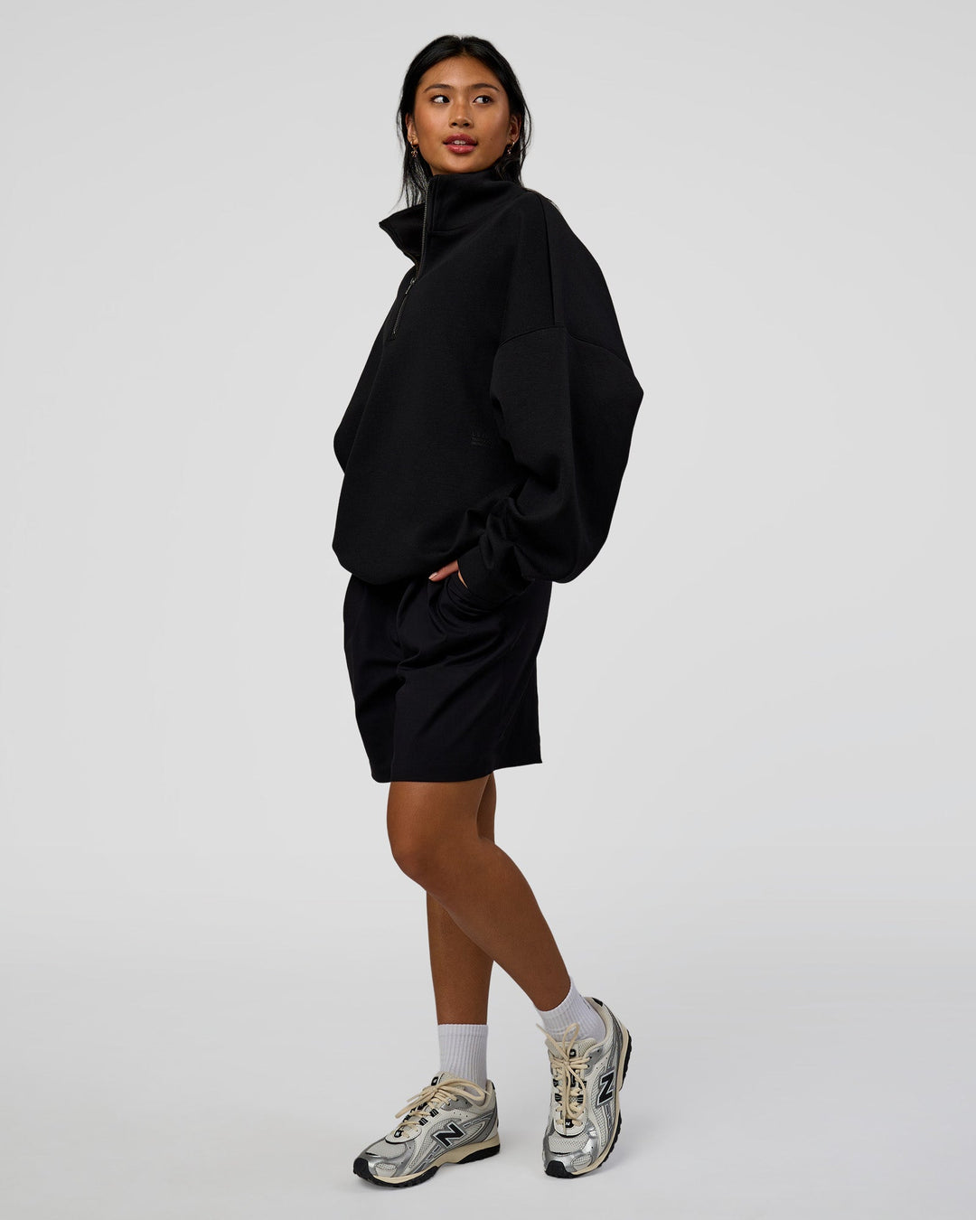 Woman wearing AfterDark ZeroCrease Quarter Zip - Black | Model:Loren | Size:XS