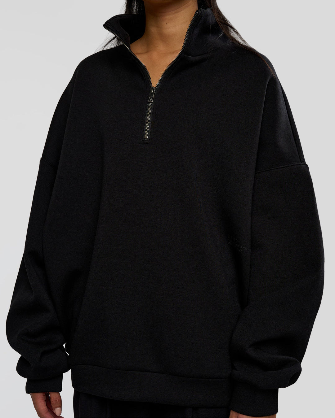Woman wearing AfterDark ZeroCrease Quarter Zip - Black | Model:Loren | Size:XS