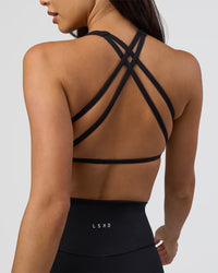 Woman wearing Aspire Sports Bra - Black | Model:Eliza | Size:XS