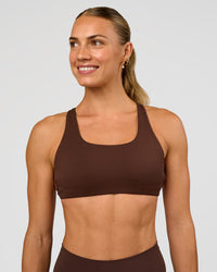 Woman wearing Aspire Sports Bra - Hot Chocolate | Model:Maja | Size:XS