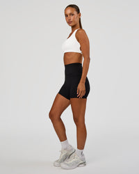 Woman wearing Aspire Sports Bra - White | Model:Brylee | Size:XS