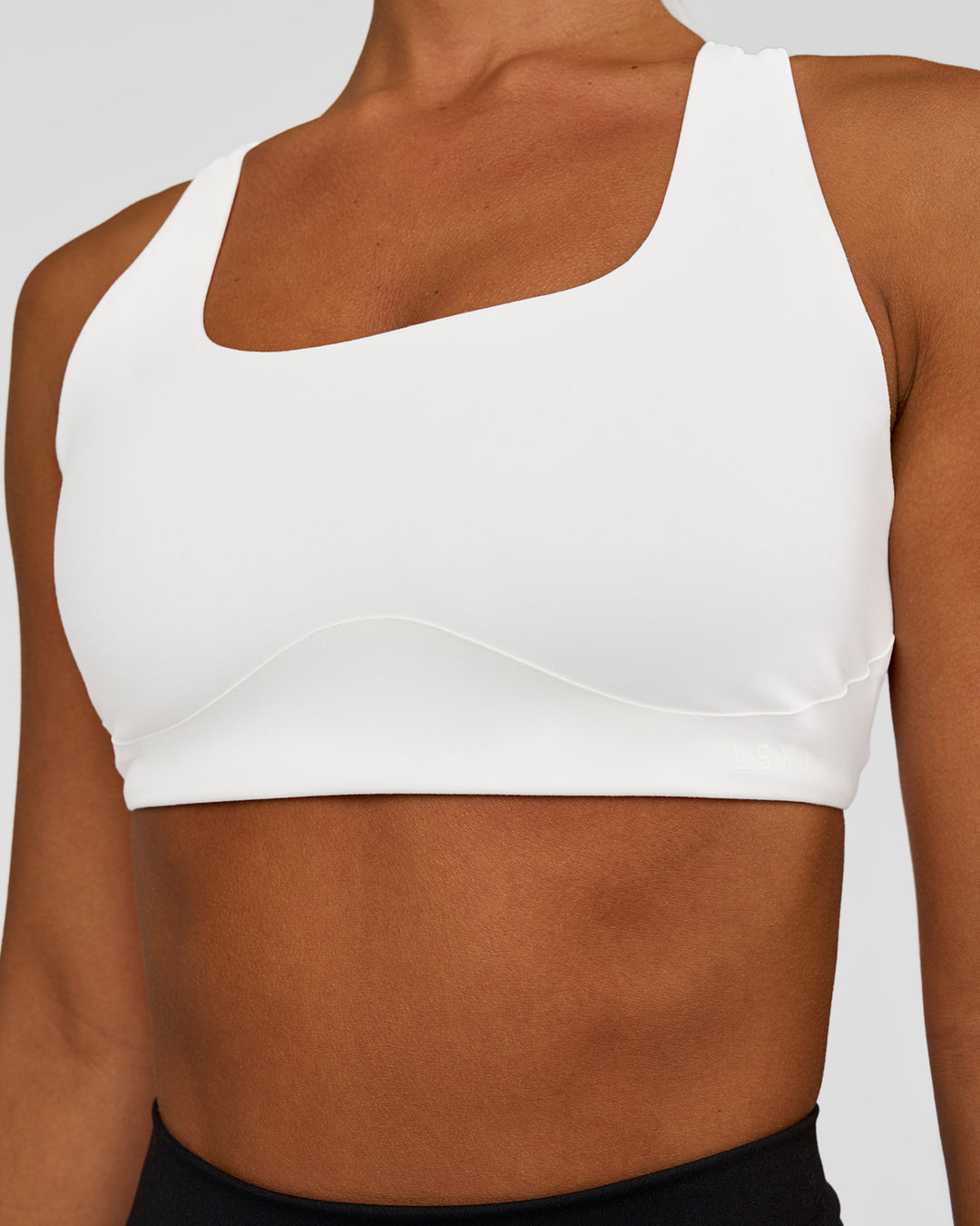 Woman wearing Aspire Sports Bra - White | Model:Brylee | Size:XS