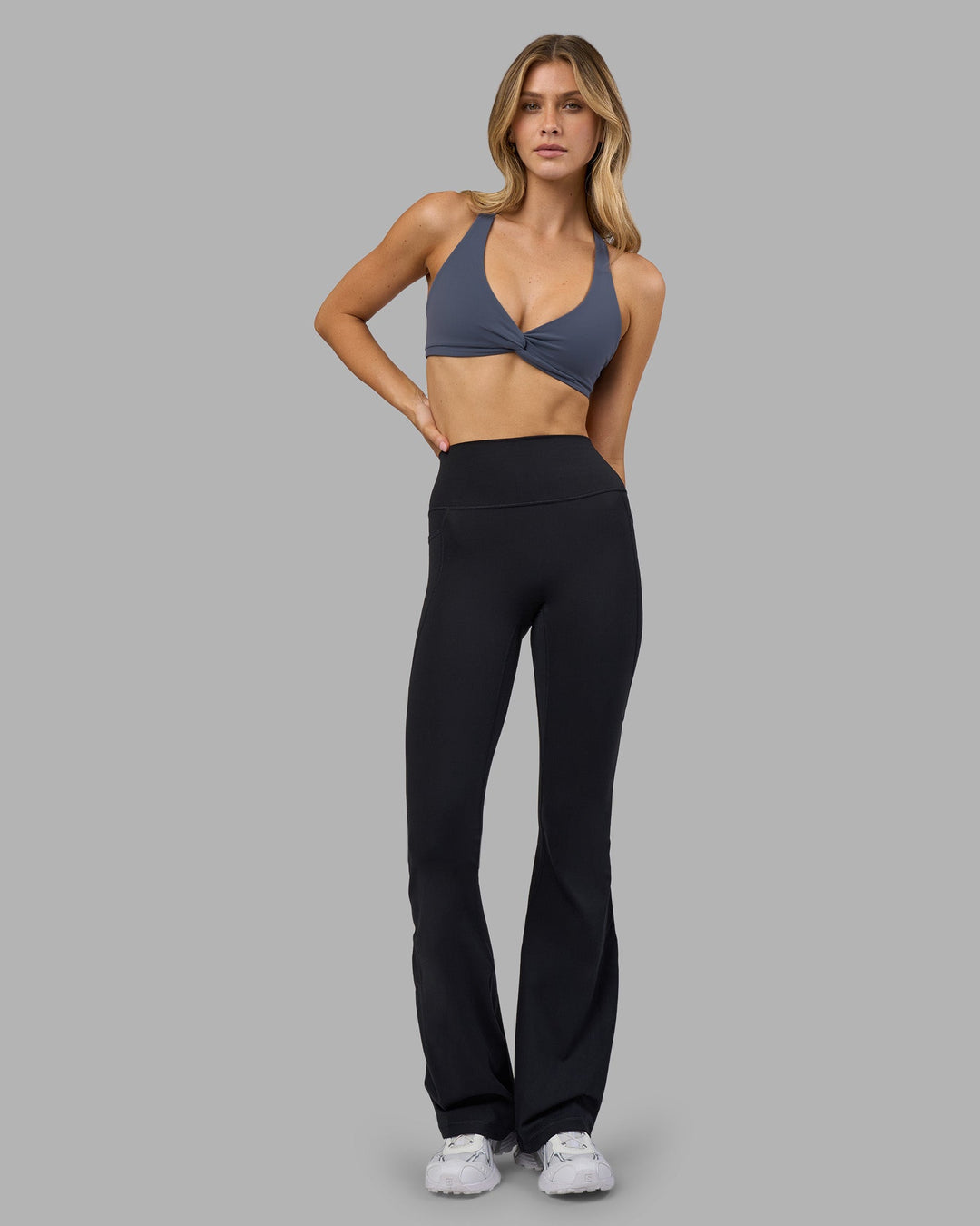Woman wearing Aspire Twist Sports Bra - Night Shadow | Model:Leilani | Size:XS