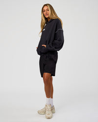 Woman wearing Axis Oversized Hoodie - Caviar-White | Model:Georgia | Size:XS