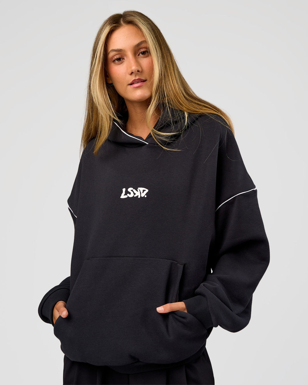 Woman wearing Axis Oversized Hoodie - Caviar-White | Model:Georgia | Size:XS