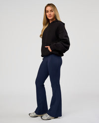 Woman wearing Base Oversized Hoodie - Black | Model:Issy | Size:XS |