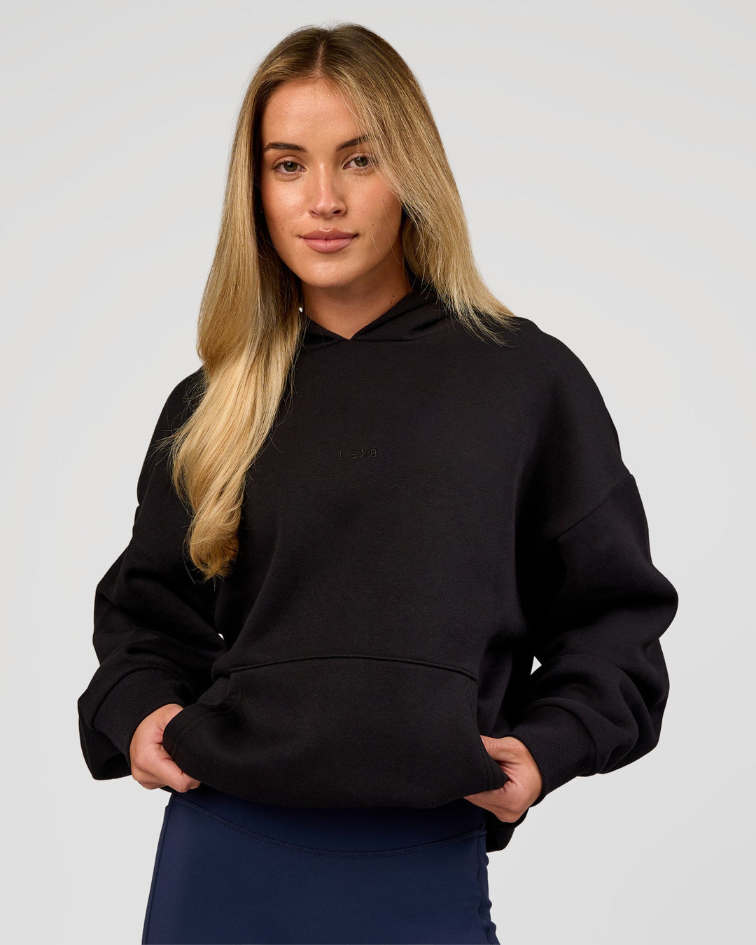 Woman wearing Base Oversized Hoodie - Black | Model:Issy | Size:XS |