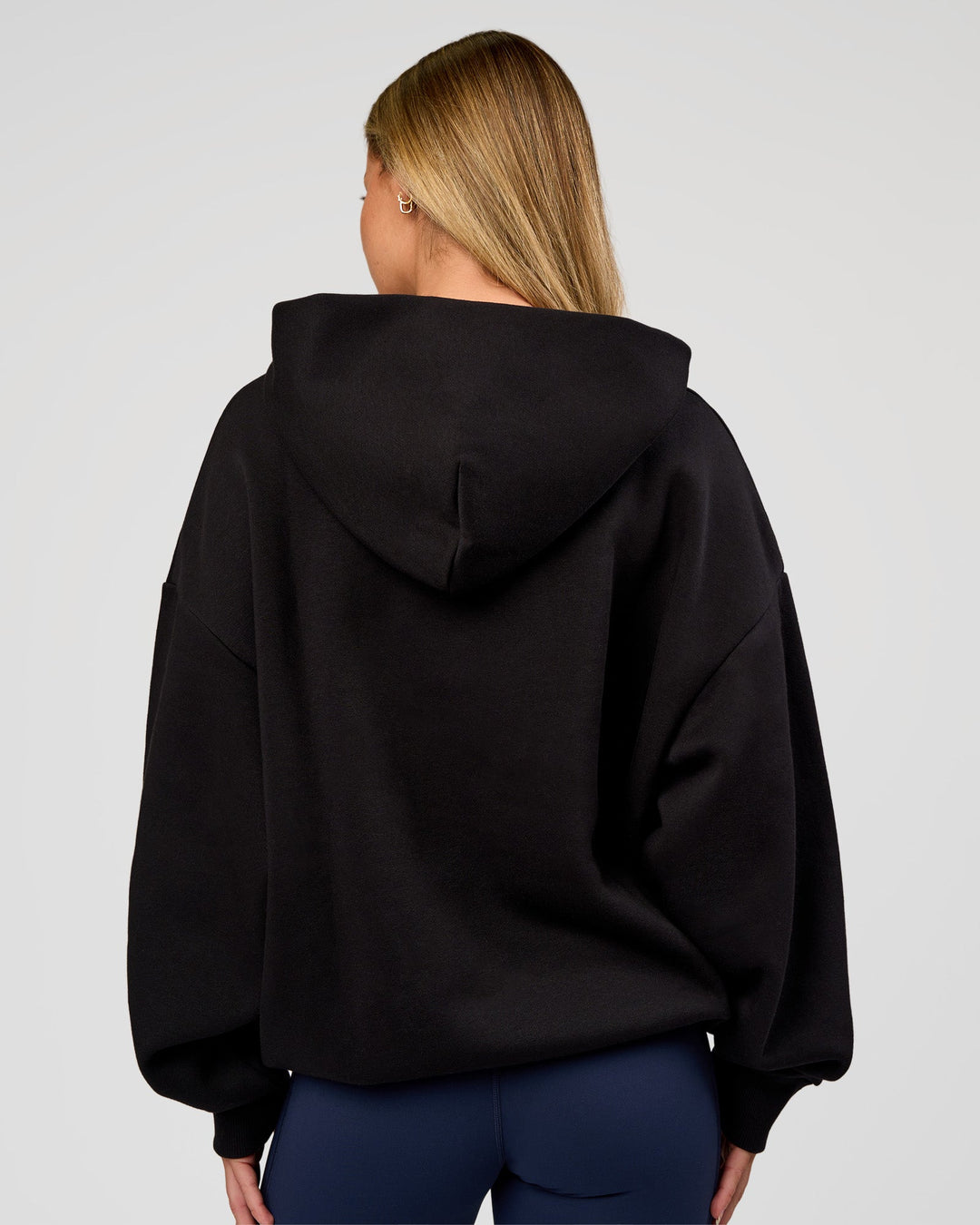 Woman wearing Base Oversized Hoodie - Black | Model:Issy | Size:XS |