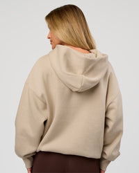 Woman wearing Base Oversized Hoodie - Shale Beige | Model:Issy | Size: XS |