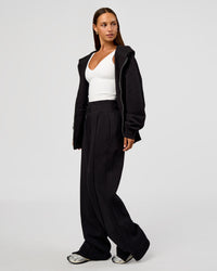 Woman wearing Base Zip Through Oversized Hoodie - Black | Model:Brylee | Size:XS