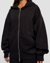 Woman wearing Base Zip Through Oversized Hoodie - Black | Model:Brylee | Size:XS