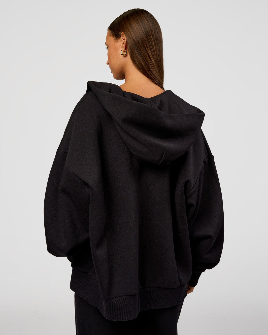 Woman wearing Base Zip Through Oversized Hoodie - Black | Model:Brylee | Size:XS