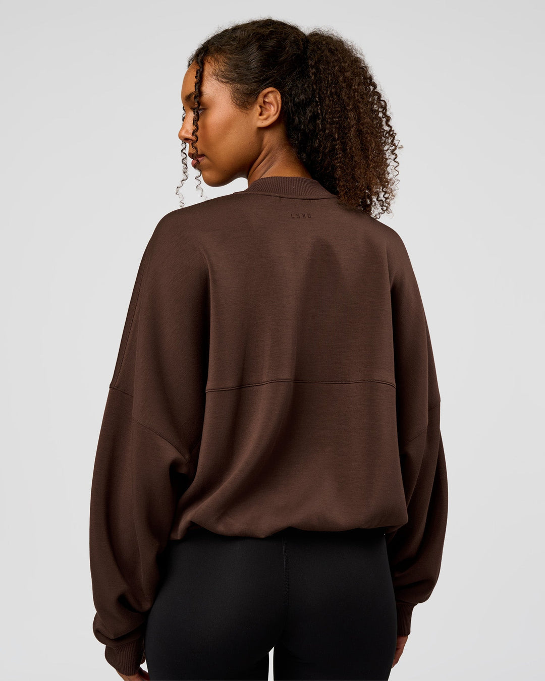 Woman wearing CF Elevate SoftTouch Bomber - Hot Chocolate | Model:Jordan | Size:XS