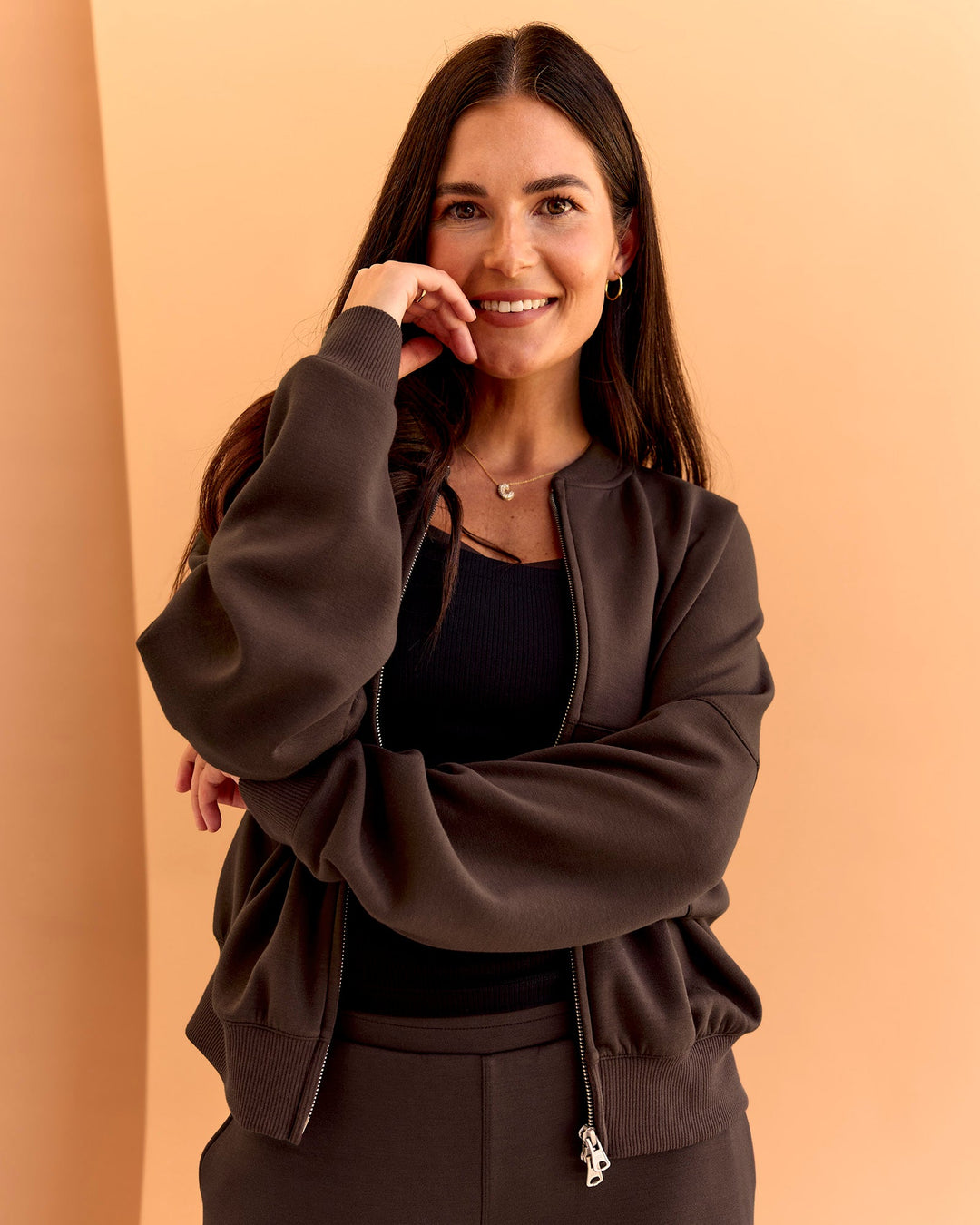 Woman wearing CF Elevate SoftTouch Bomber - Hot Chocolate | Model:Chloe | Size:XS