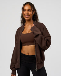 Woman wearing CF Elevate SoftTouch Bomber - Hot Chocolate | Model:Jordan | Size:XS
