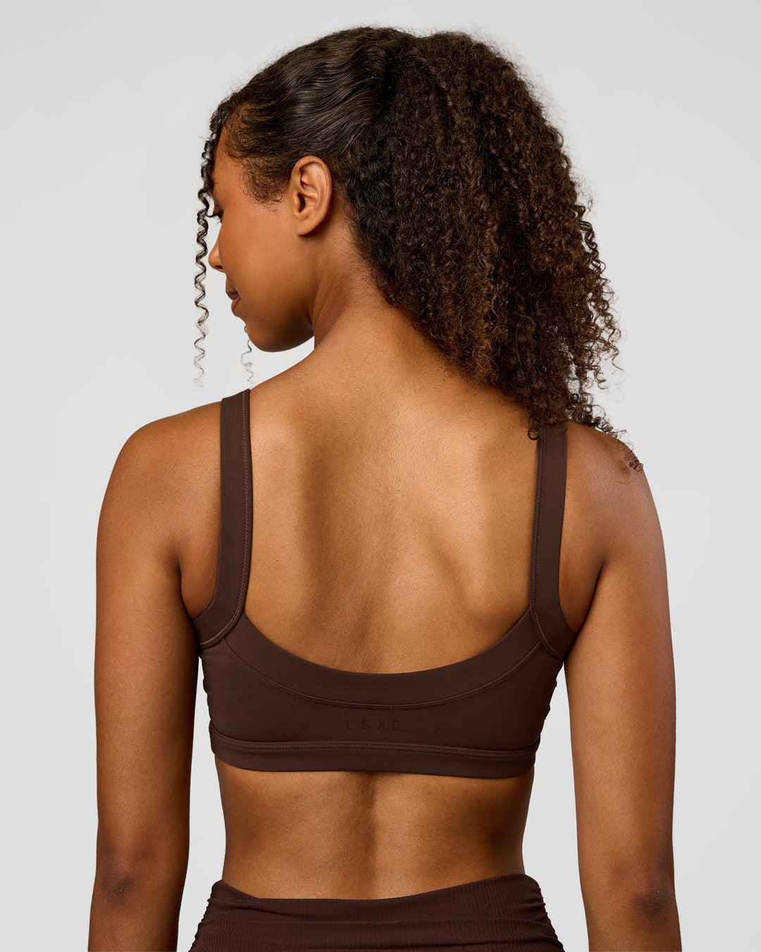 Woman wearing CF Move Through It Sports Bra - Hot Chocolate | Model:Jordan | Size:XS