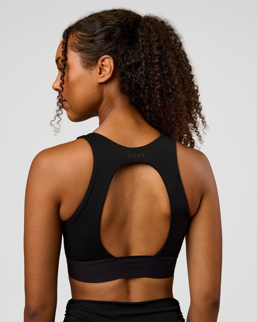Woman wearing CF Train Hard Sports Bra - Black | Model:Jordan | Size:XS