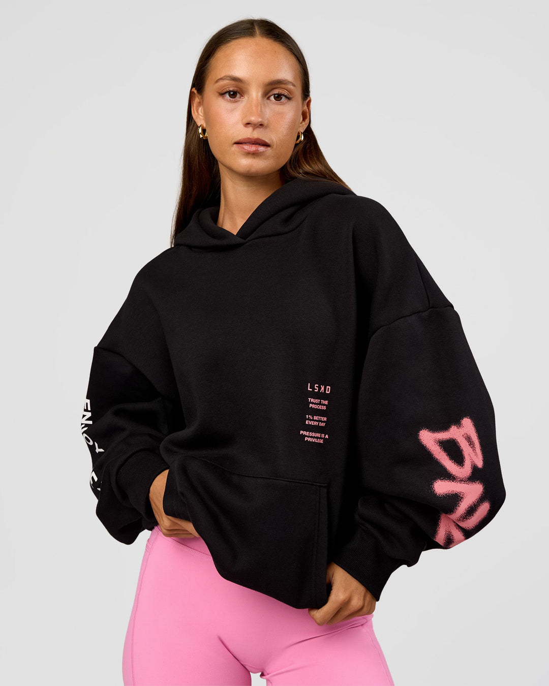 Woman wearing CFT BNE 26 Unisex Oversized Hoodie - Black-Candy Pink | Model:Brylee | Size:XS