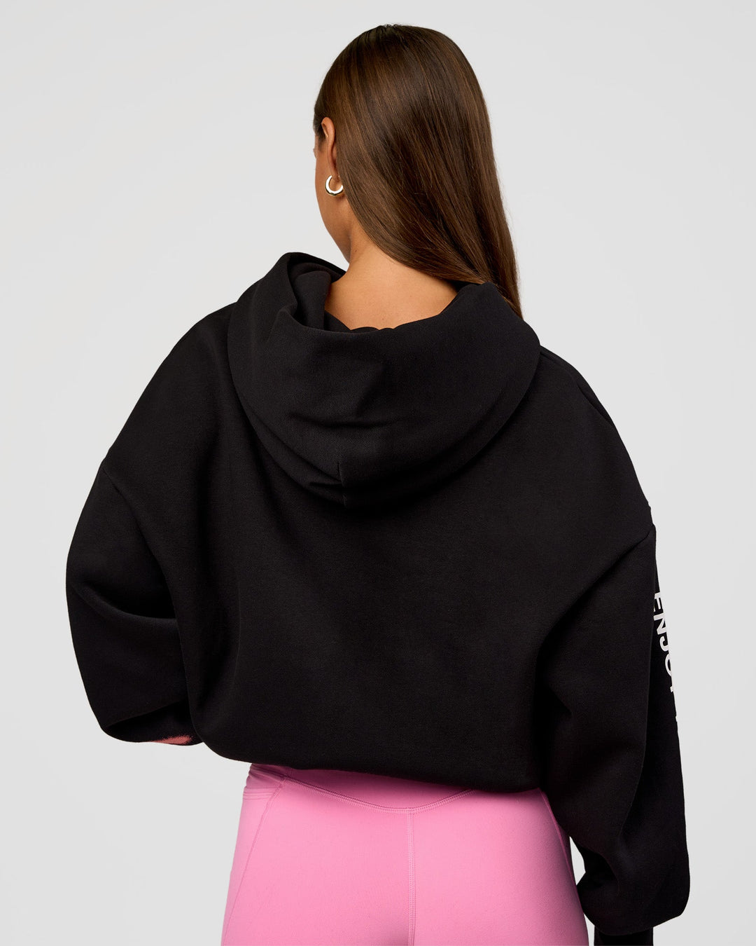 Woman wearing CFT BNE 26 Unisex Oversized Hoodie - Black-Candy Pink | Model:Brylee | Size:XS